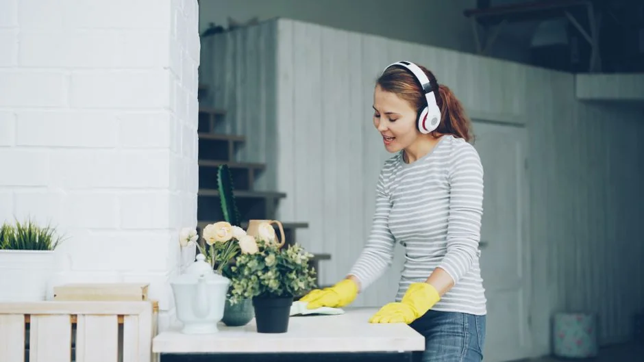 creative Cleaner using a vacuum in a stylish indoor setting, showcasing cleaning equipment and techniques.